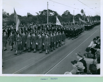 A group of Catholic College groups crossing the Princes Bridge marching towards to the Melbourne Town Hall on Swanston Street, Melbourne CBD Australia - 1948, from the War Memorial - Department of Health – National Fitness Office (Sports & Recreation) – Historical Press Release Photo Collection