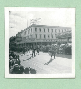 Cadets taking the salute, passing Turnbridges Arcade & Crockers Drapery on Sturt Street - Note: Tram tracks - Ballarat on Empire Youth day march held in Ballarat in 1958 - Department of Health – National Fitness Office (Sports & Recreation) – Historical Press Release Photo Collection