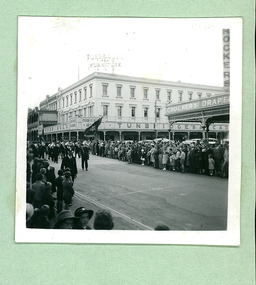 A brass band, passing Turnbridges Arcade & Crockers Drapery on Sturt Street - Note: Tram tracks - Ballarat on Empire Youth day march held in Ballarat in 1958 - Department of Health – National Fitness Office (Sports & Recreation) – Historical Press Release Photo Collection