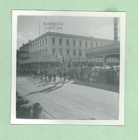 Boy Scouts and Cubs passing Turnbridges Arcade and Crockers Drapery on Sturt Street - Note: Tram tracks - on Empire Youth day march held in Ballarat in 1958 - Department of Health – National Fitness Office (Sports & Recreation) – Historical Press Release Photo Collection