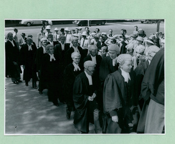 A photo of judges entering a building two-by-two in Melbourne Australia - Department of Health – National Fitness Office (Sports & Recreation) – Historical Press Release Photo Collection