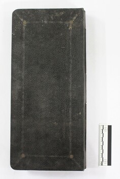Back cover of a Kalamazoo visible card book used for accounting in the J. Mann & Sons General Store in Wodonga, Victoria. Black and white 10 cm scale to one side.