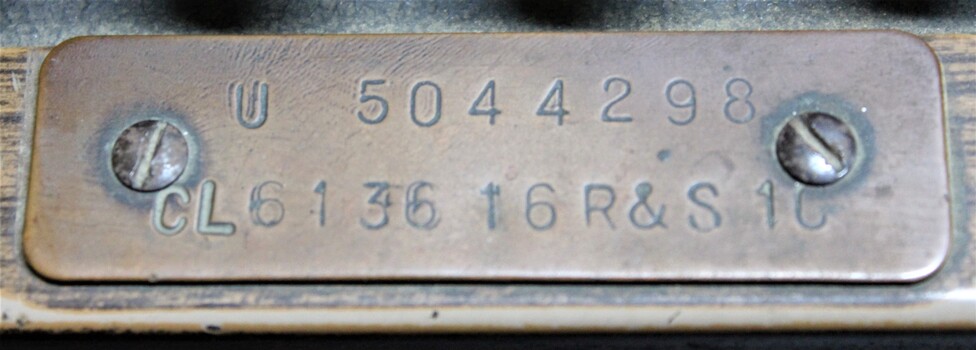Small metal/copper plate with the serial numbers of the National cash register used in the J. Mann & Sons General Store in Wodonga, Victoria.