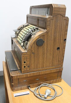 One side of the National cash register used in the J. Mann & Sons General Store in Wodonga, Victoria with a 10 cm scale.