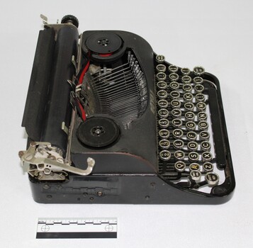 Side view of black vintage typewriter 