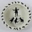 Birds eye view of a white ceramic child's bowl with black print depicting a child dancing with three cats in the centre of the bowl. A circular print around the edge of the bowl features animals including roosters, squirrels, dogs, cats, rabbits and geese