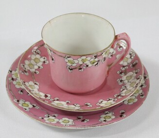 Haeusler Collection Teacup, Saucer and Cake Plate is pink with a flower pattern