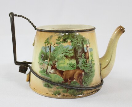Side view of Haeusler Collection Teapot showing a print of two deer and a hunter in a woodland