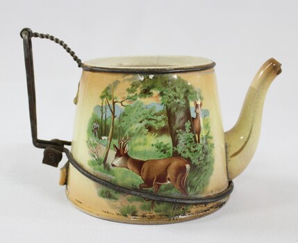 Side view of Haeusler Collection Teapot showing a print of two deer and a hunter in a woodland