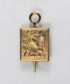 Front of a small gold metal pin for 15 years, with a pearl inlay.