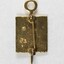Back of a small gold metal pin for 15 years, with a pearl inlay visible and a clasp attached.