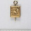 Front of a small gold metal pin for 15 years, with a pearl inlay and a 5 cm black and white scale.