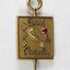 Front of a Sarah Coventry gold metal pin for five years service, with a faceted pink stone inlay on the proper left side.