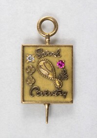 Front of a Sarah Coventry gold metal pin for ten years service, with a faceted pink stone inlay on the proper left side and a faceted clear stone on the proper right side.