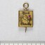 Front of a Sarah Coventry gold metal pin for ten years service, with a faceted pink stone inlay on the proper left side and a faceted clear stone on the proper right side, and a 5 cm black and white scale.