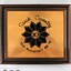 Front of a brown wooden fame on a copper plaque commemorating Sarah Coventry 10th Anniversary from 68-78, with a 5 cm black and white scale.