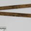 Wooden fold out carpenter ruler with bendable brass hinges and imperial measurements engraved into the wood, pictured with 10cm scale