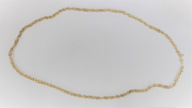 Gold toned metal chain in a side-on view.