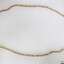 Gold toned metal chain from the Sarah Coventry jewellery range with a 5 cm black and white scale.