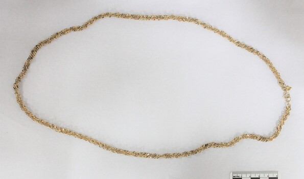 Gold toned metal chain from the Sarah Coventry jewellery range with a 5 cm black and white scale.