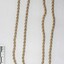 Gold toned beaded metal chain from the Sarah Coventry jewellery range, with a black and white 5 cm scale.