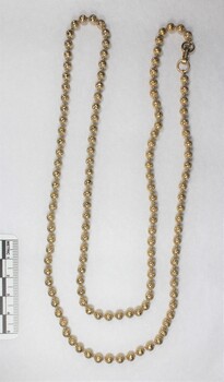 Gold toned beaded metal chain from the Sarah Coventry jewellery range, with a black and white 5 cm scale.