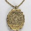 Detail of the back of the gold toned metal oval pendant and the Sarah Coventry copyright on the lower back surface.