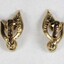 Back of two gold toned plated metal clip-on earrings, with the Sarah Coventry mark on the back of the clip on each earring.