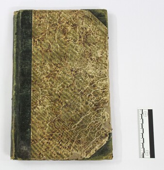 Front of a Wodonga Police register or diary used for recording day-to-day duties in 1855-1857, with a black and white 10 cm scale.