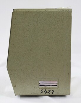 Proper left side of the green metal surface of the Amano time clock with a small metal plate with the model and serial numbers, plus "S 422" written in black marker below.