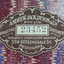 Adhesive paper label on the marbled paper surface of the inside front cover.