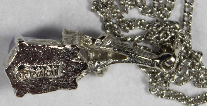 Close up detail of Sarah Coventry makers mark on reverse of pendant 