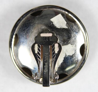 Reverse of Silver toned Dome Shaped Clip on Earrings from the Sarah Coventry Jewellery Range c. 1970s-1980s, showing makers mark