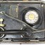 Lower part of a metal case containing a black rotary dial flameproof telephone, with rubber tubing attached to the handset and a metal plate with the maker's name and the type and certification of the telephone.