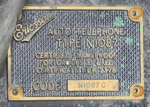 Detail of the metal plate with the maker's name, type and code number, and certification of the flameproof telephone.