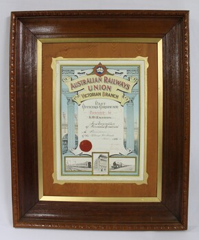 Dark brown wooden frame on a colour certificate for past officers in the Wodonga sub-branch of the Victorian Branch of the Australian Railways Union.