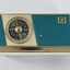 A blue, cream and gold chrome radio face with AWA logo and tuning panel. 