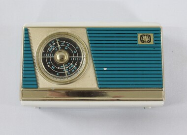 A blue, cream and gold chrome radio face with AWA logo and tuning panel. 