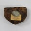 Lump of tobacco with Havelock Tobacco makers mark on tin insert, with manufacture details on paper