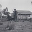 Black and white photograph of a farm house surrounded by trees 