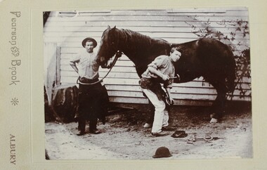 Photo of two men and horse.