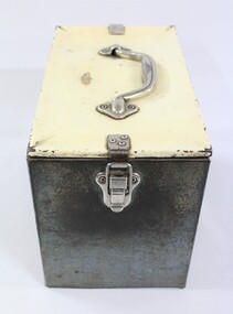 One end of a rectangular grey metal railways lunch box.