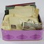 A purple tin full of letters, foreign money and savings bank passbooks