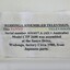 Paper label attached to the upper back of television.