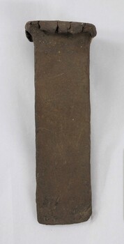 One side of a hand forged iron alloy iron wedge.