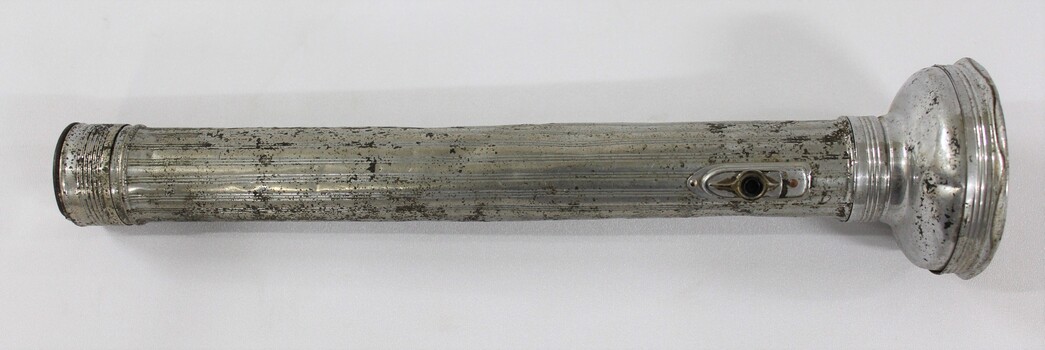 Side view of a metal torch.