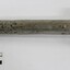 Side view of a metal torch with scale.