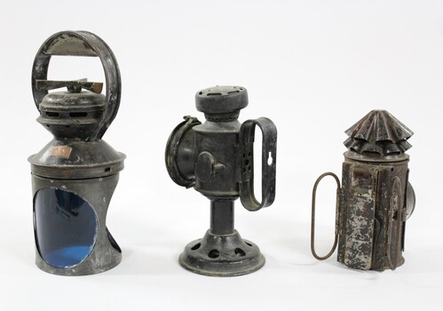 Three metal and glass Signal lamps.