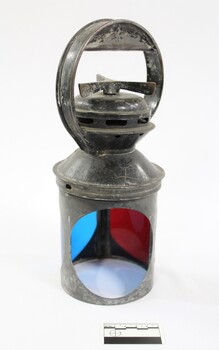 Exterior casing of a black painted metal railway signal.