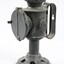 Side view of a black painted metal signal lamp.